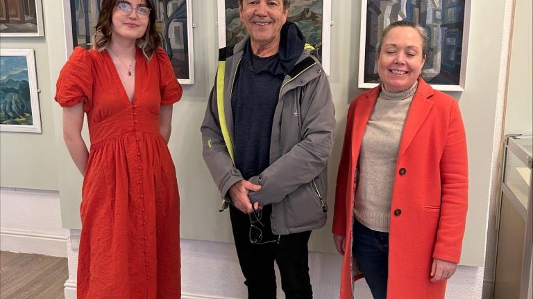Robert Lindsay with two museum staff in front of the exhibition at Erewash Museum