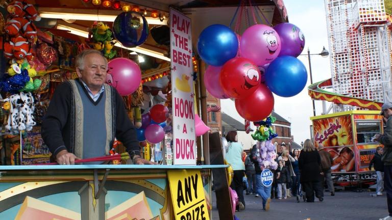 A man stands on his hook a duck stall