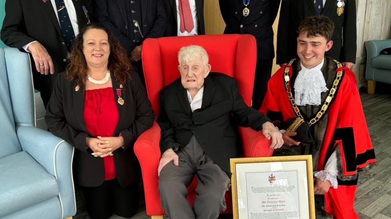 Donald Rose with the delegation and his certificate