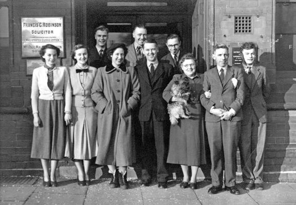 Paul Robinson, centre with wife Hope, in a staff photo at the Ilkeston solicitors he