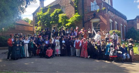 A group photo of people dressed up for a steampunk event