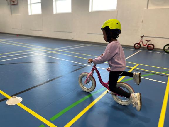 child on balance bike