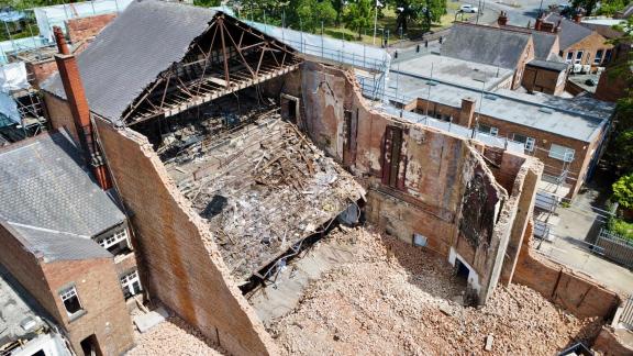 The building now it is half demolished drone shot