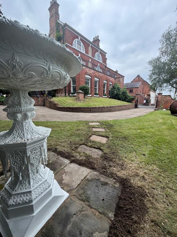 The Handyside Urn in the museum's garden, with Erewash Museum in the background