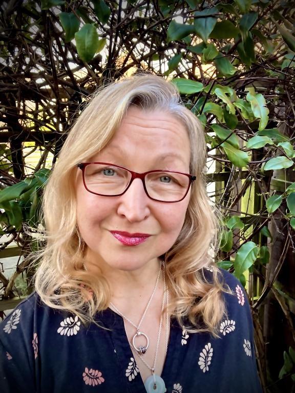 Nikki Hall, lady with blonde hair and glasses smiles