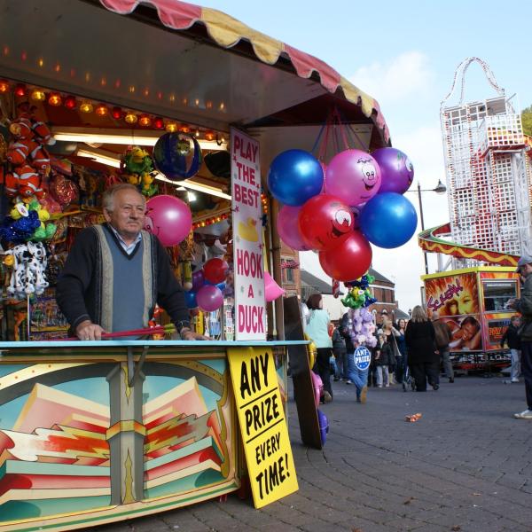 A man stands on his hook a duck stall