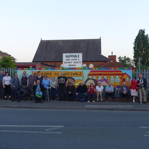 A group photo of volunteers and members in front of Happivale Social Club