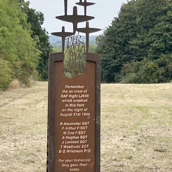 The memorial which is bronze and has bombers on  top